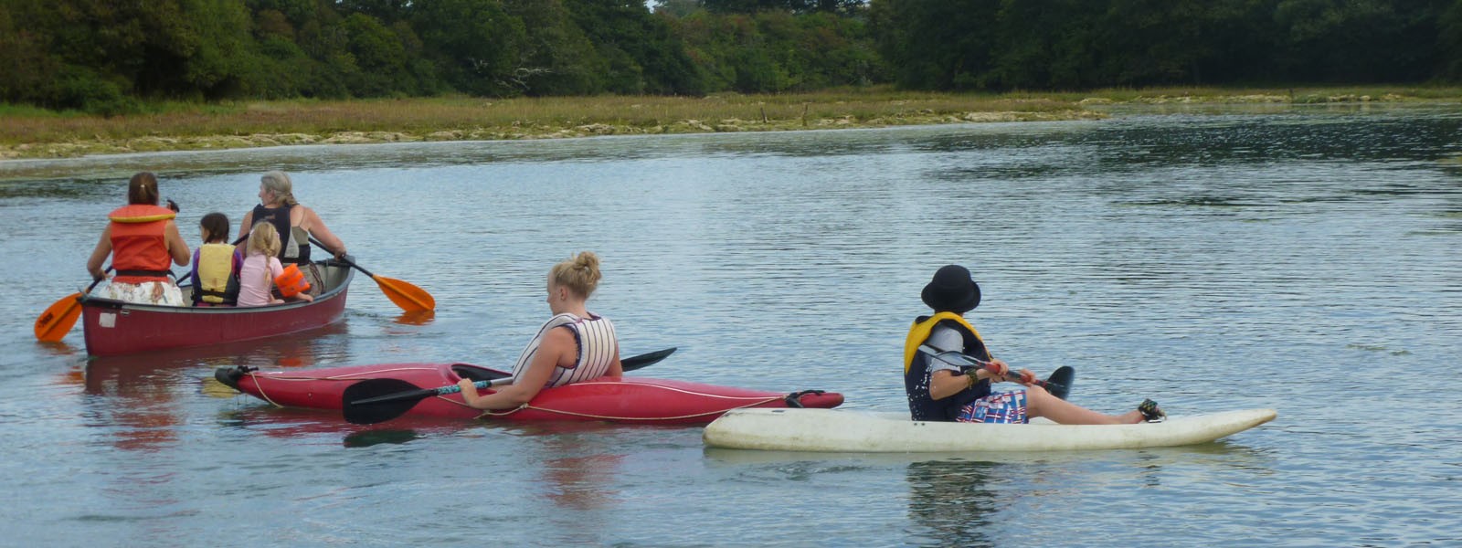 People exploring the West Wight rivers by canoe